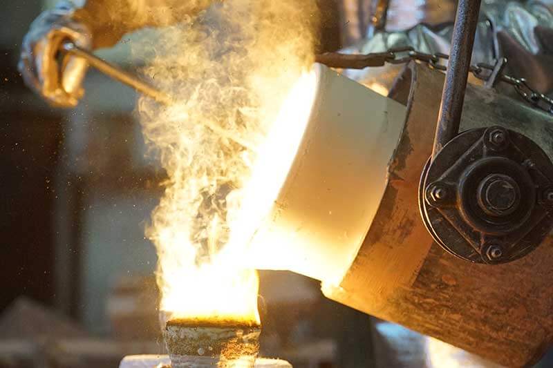 showing alloys being poured for casting stainless steel